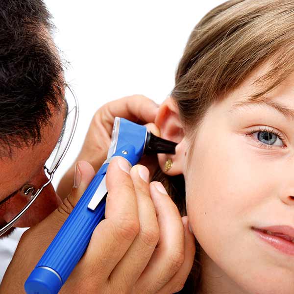 doctor looking in woman's ear