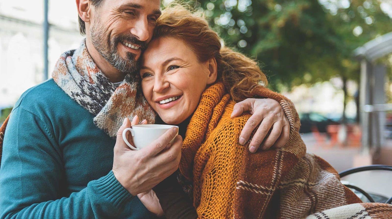 A couple smiles over coffee