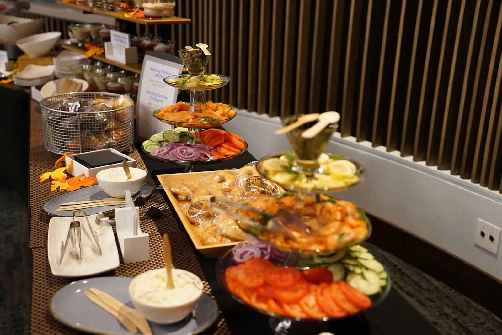 Breakfast buffet with a tiered bagel tower and smoked fish platters at the senior living round table in San Francisco